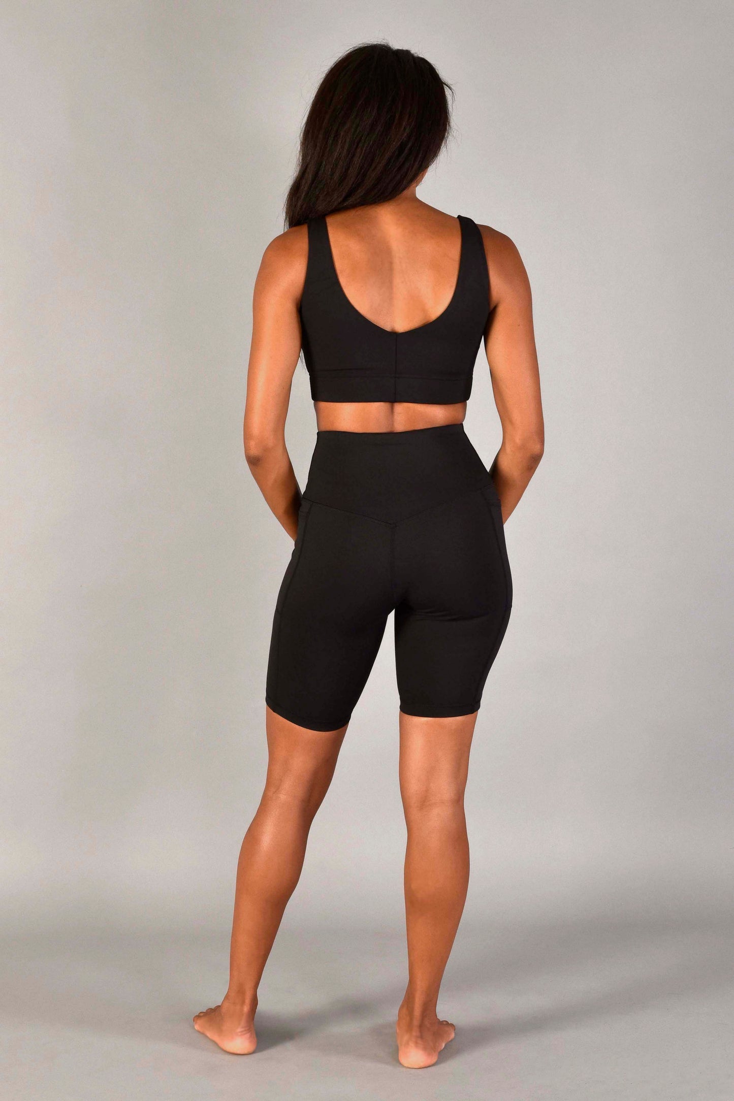 high rise recycled core compression tri-pocket 9" short in matte black by wear love more